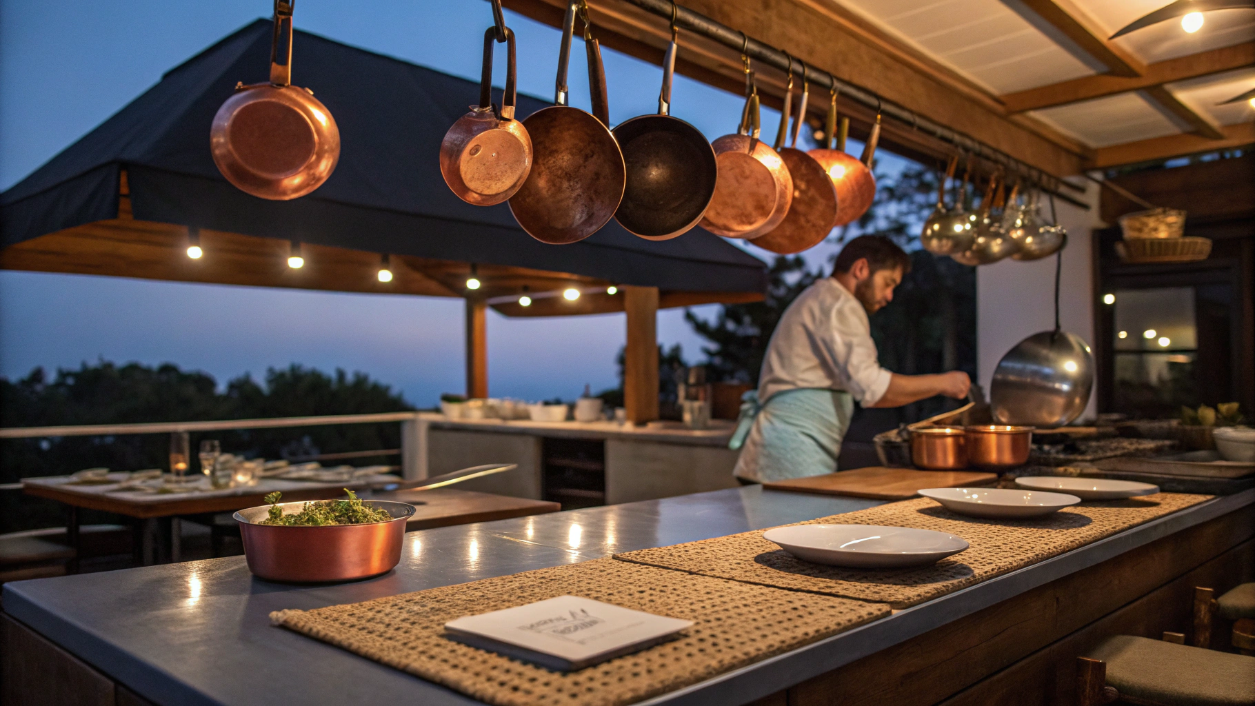 Cinematic view of a professional kitchen with warm lighting and refined culinary preparation